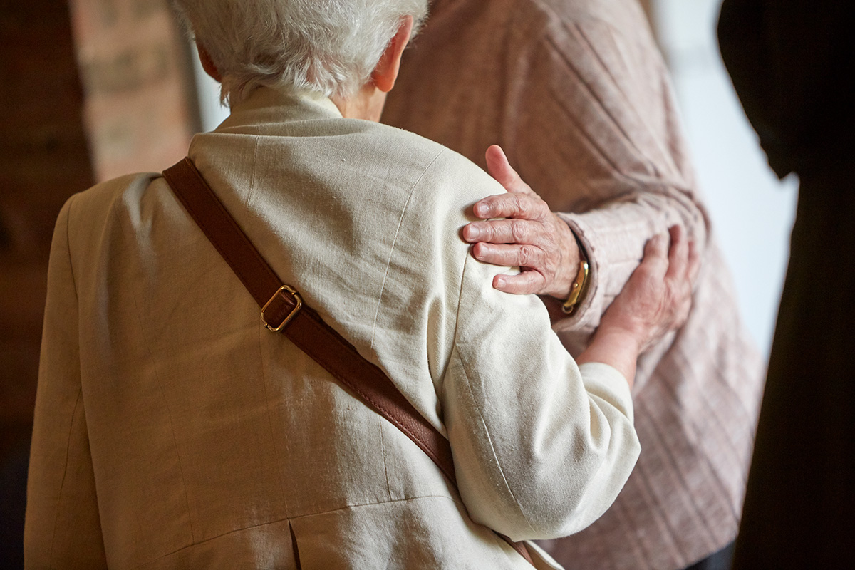A Friend puts her hand on another Friend's shoulder