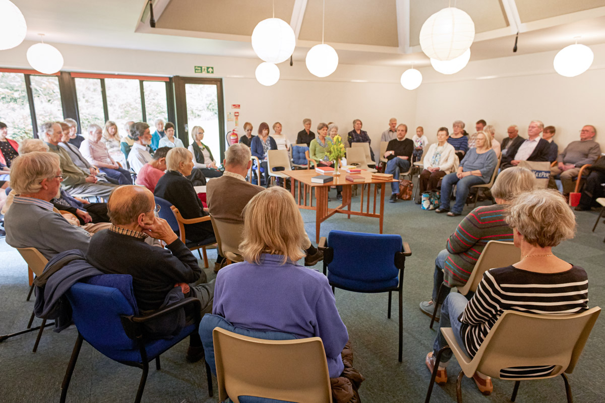 A group of people sitting in a circle at a Quaker meeting